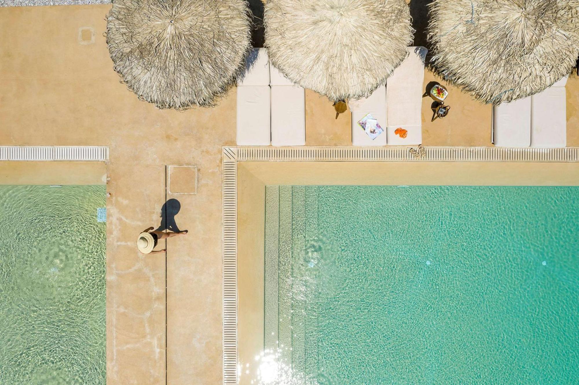 Isla Brown Corinthia Resort & Spa, Curio Collection By Hilton Agioi Theodoroi Esterno foto Aerial view of the pool
